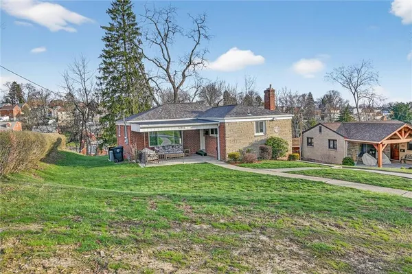 a front view of house with yard and green space