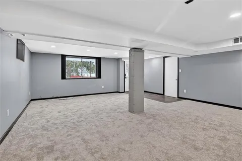an empty room with windows and closet