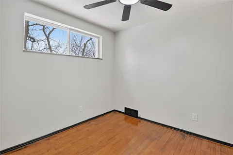 an empty room with a painting on the wall