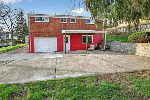a view of a house with a yard and garage