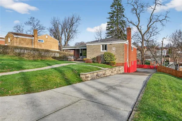 a front view of house with yard and green space