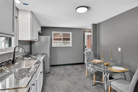 a kitchen with stainless steel appliances granite countertop a sink stove and cabinets