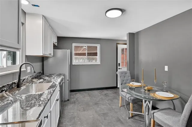 a kitchen with stainless steel appliances granite countertop a sink stove and cabinets
