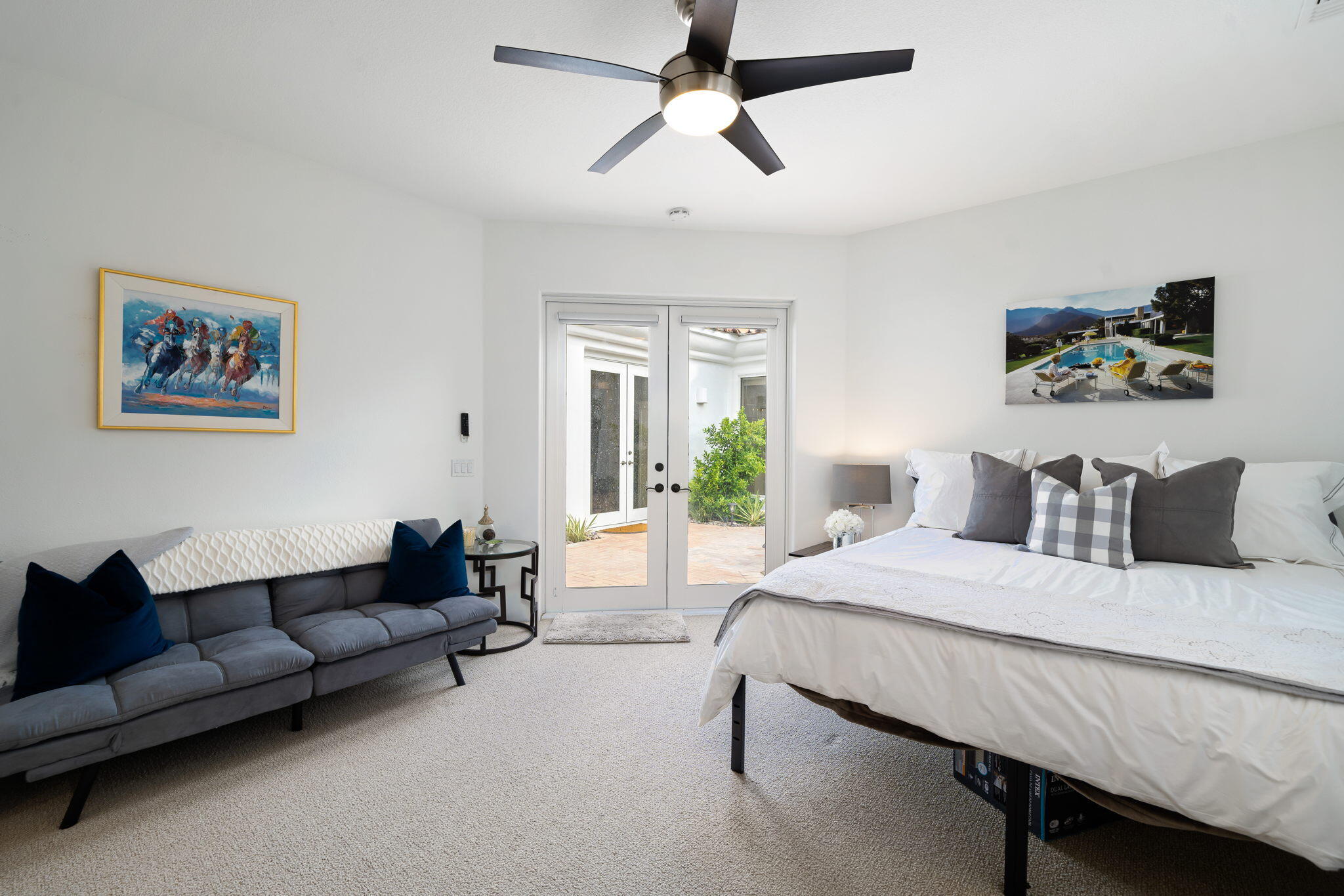 207 Loch Lomond Road Rancho Mirage, CA 92270 - Photo 34 of 50 a spacious bedroom with a bed a couch and a chandelier fan