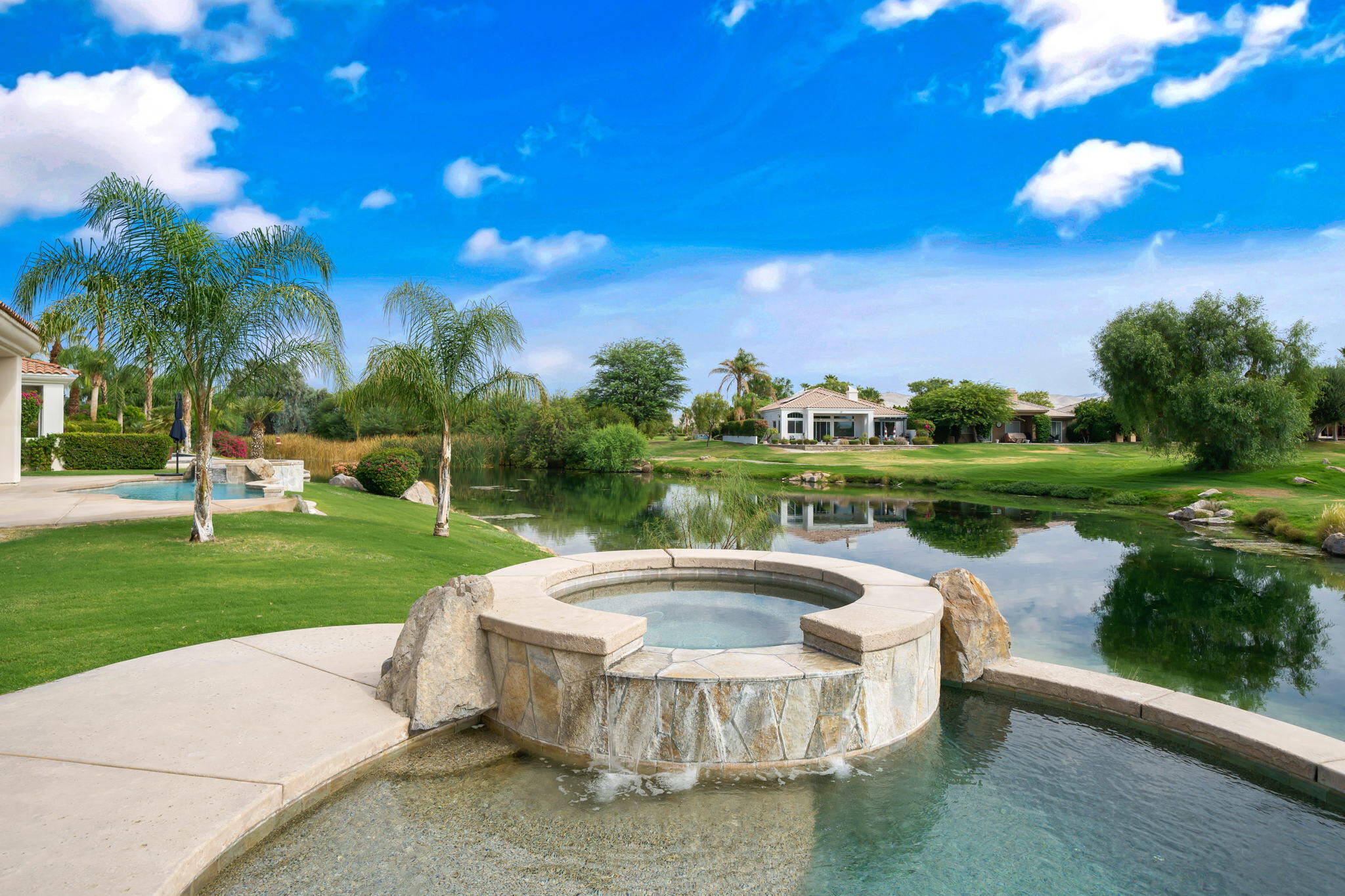 207 Loch Lomond Road Rancho Mirage, CA 92270 - Photo 38 of 50 a view of a fountain in a yard with palm trees