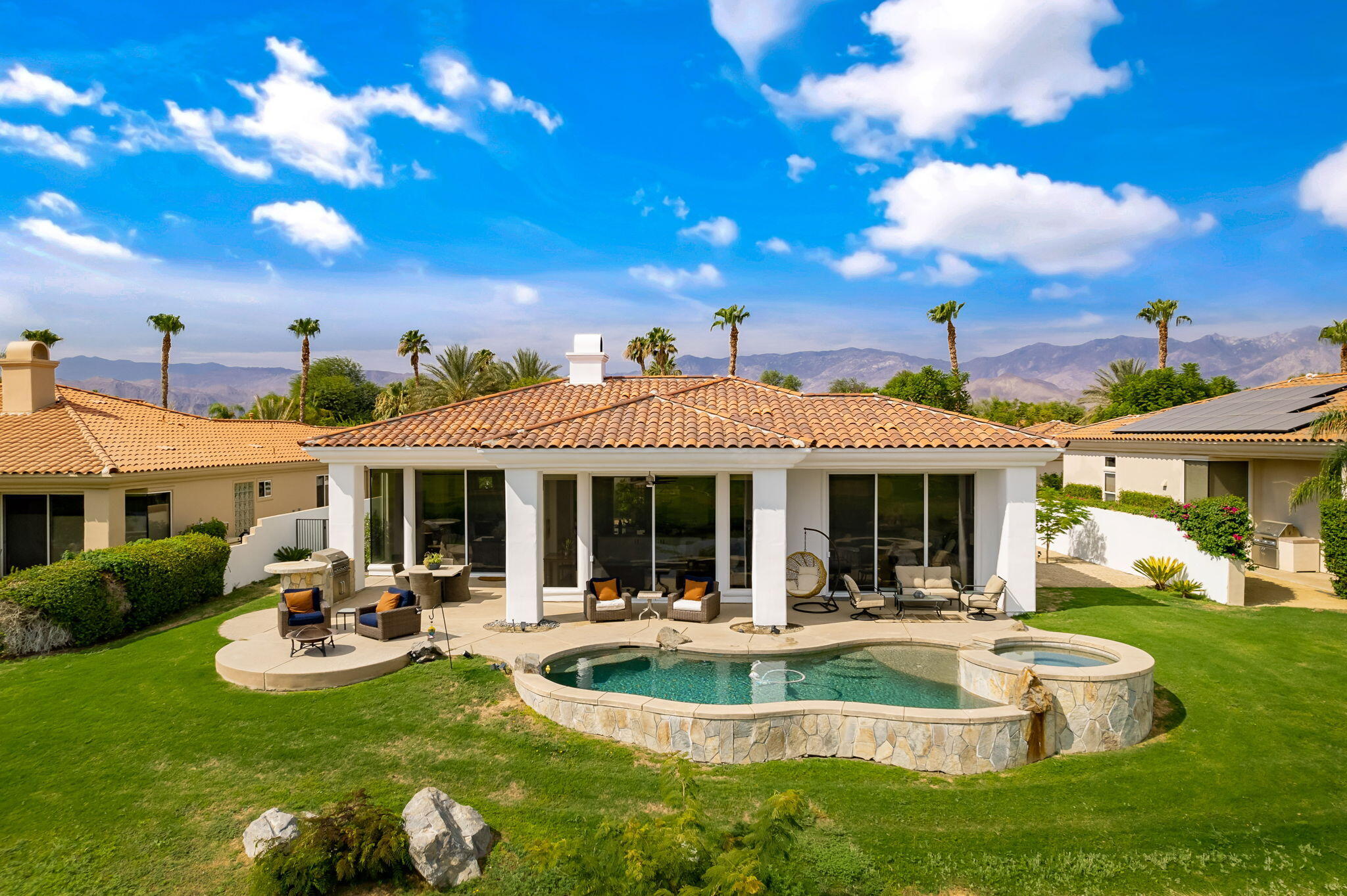 207 Loch Lomond Road Rancho Mirage, CA 92270 - Photo 49 of 50 a front view of a house with swimming pool and couches