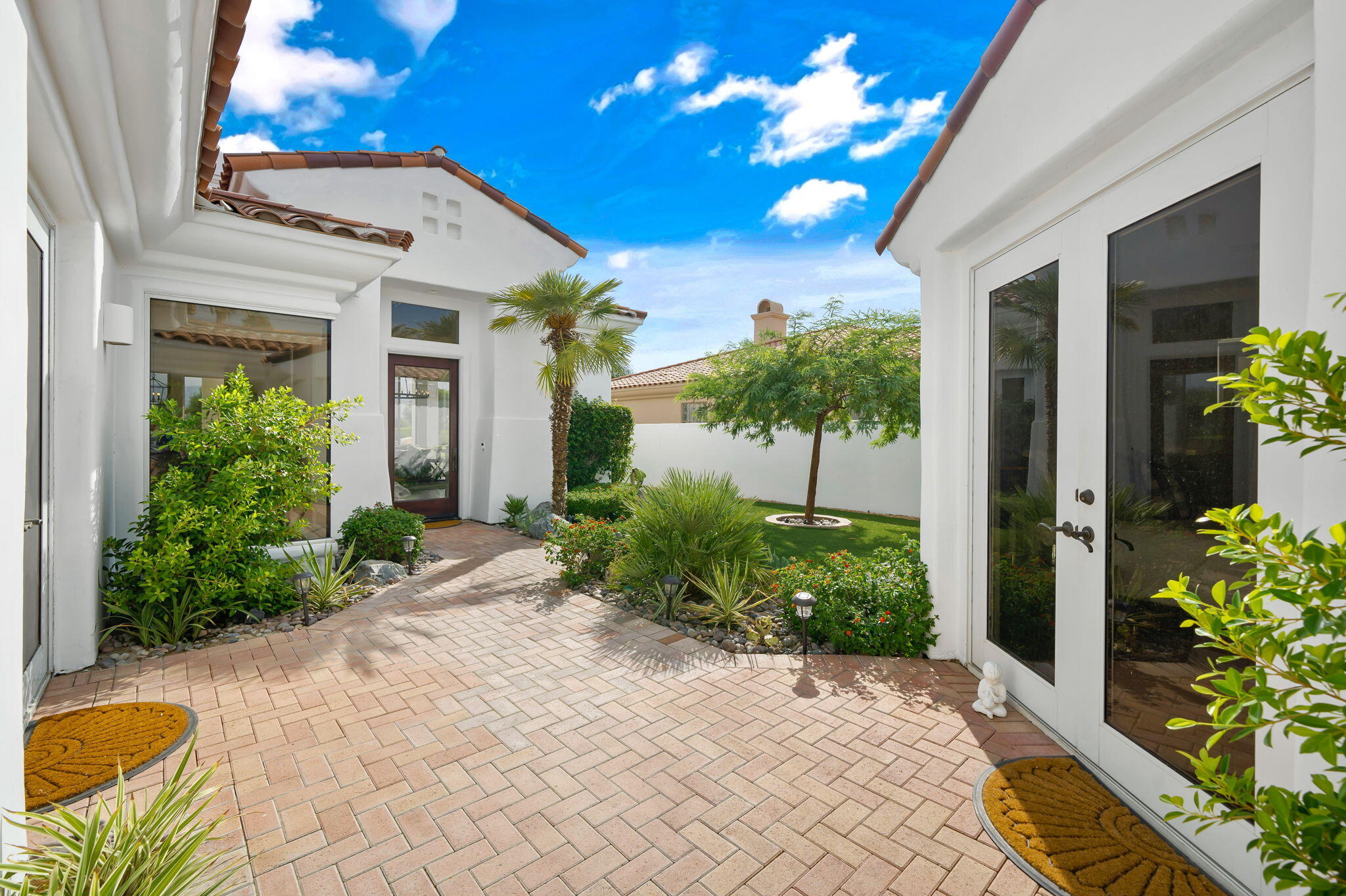 207 Loch Lomond Road Rancho Mirage, CA 92270 - Photo 8 of 50 a view of a house with potted plants