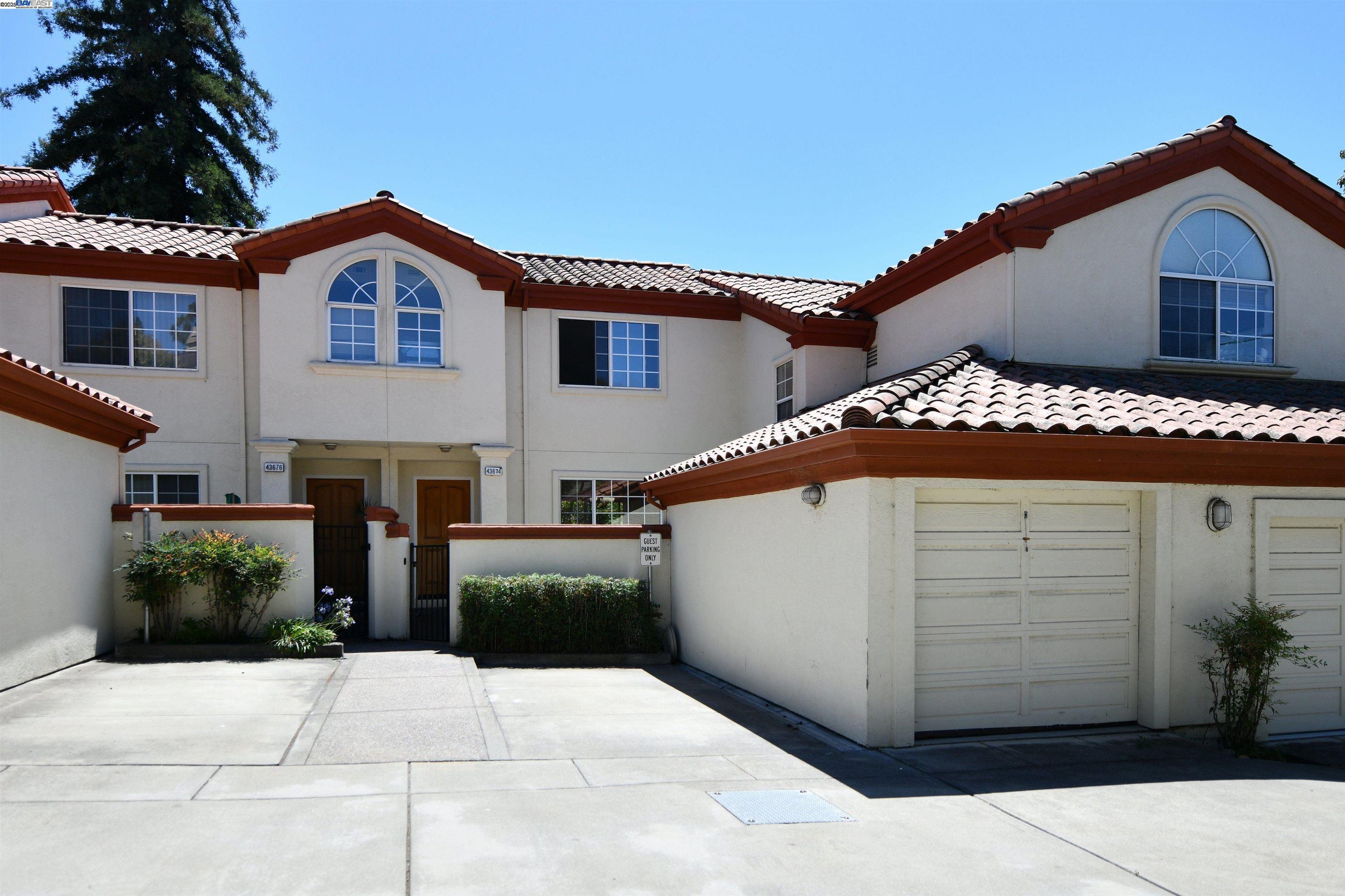 43674 Ellsworth Street, Unit 2 Fremont, CA 94539 - Photo 1 of 1 a front view of a house with a garage
