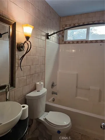 a bathroom with a toilet and shower