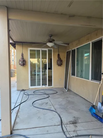 a view of a patio with table and chairs potted plants with wooden floor