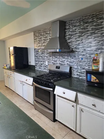 a kitchen with stainless steel appliances and cabinets