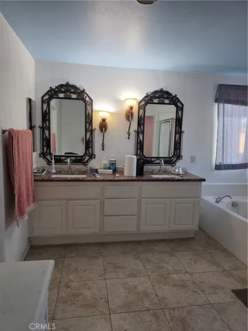 a bathroom with a sink a mirror and bathtub