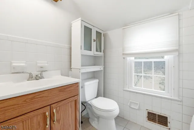 a bathroom with a sink a toilet and a window