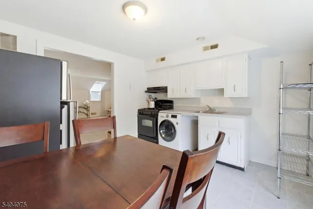 a view of a kitchen and dining room with furniture