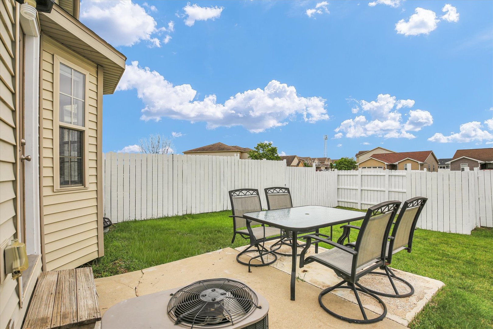 3715 Boulder Ridge Drive Champaign, IL 61822 - Photo 27 of 29 a view of a patio with table and chairs with wooden floor and fence