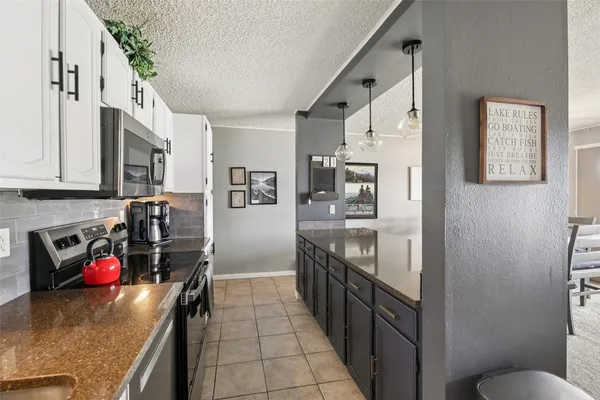 a bedroom with a large bed and a tv on dresser