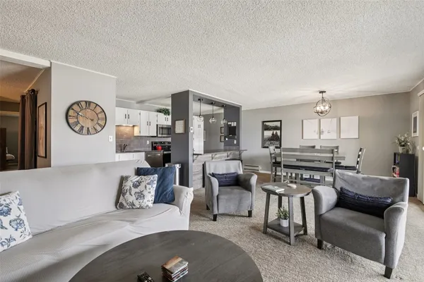 a kitchen with stainless steel appliances granite countertop a refrigerator sink and stove