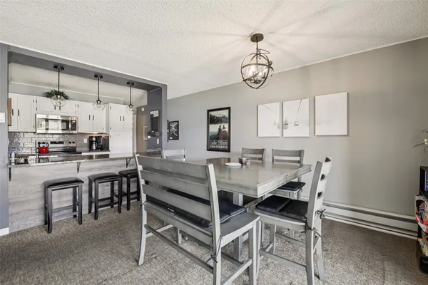 a kitchen with stainless steel appliances granite countertop a sink refrigerator and cabinets