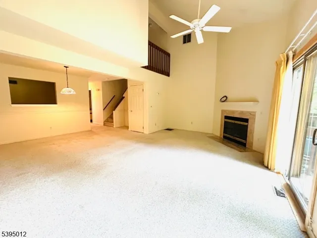 a view of a livingroom with a fireplace and a ceiling fan