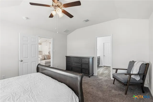 a bedroom with a bed and a chair