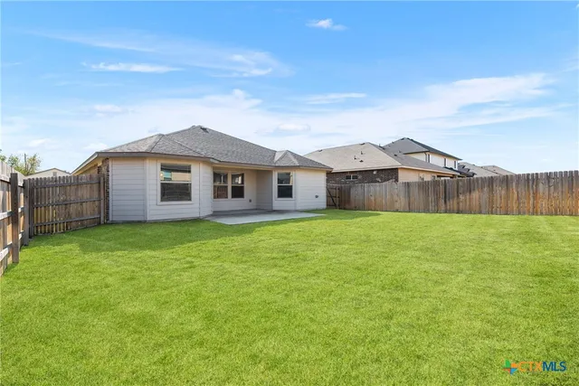 a view of a house with a backyard