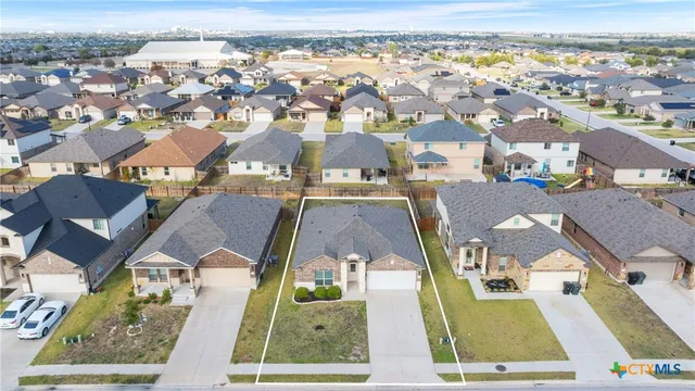 an aerial view of residential houses with outdoor space