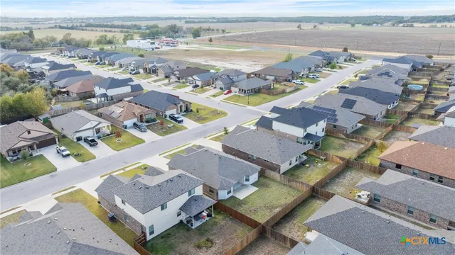 an aerial view of residential houses with outdoor space