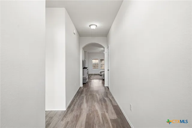 a view of a room with wooden floor
