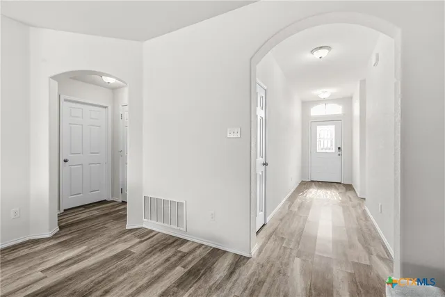 a view of hallway with wooden floor
