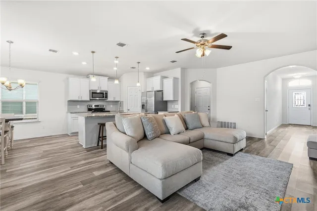 a living room with furniture and kitchen view