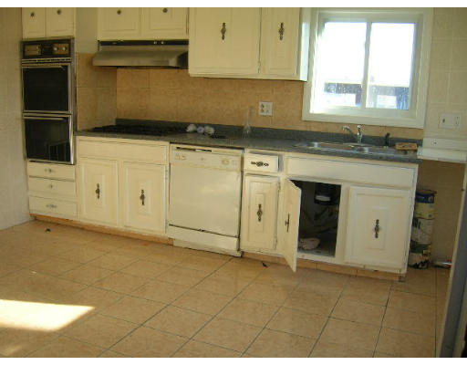 295 Shirley Street, Unit 2 Winthrop, MA 02152 - Photo 4 of 12 a kitchen with granite countertop a stove a sink and a microwave