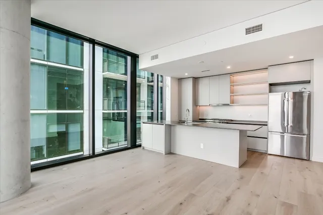 a kitchen with stainless steel appliances granite countertop a refrigerator and a sink
