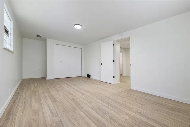 a view of an empty room and wooden floor