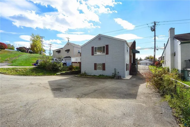 a view of a house with a backyard and garden