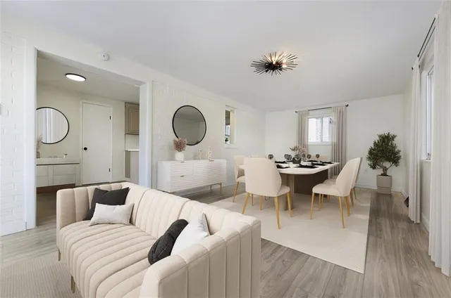 a living room with furniture a rug and a chandelier