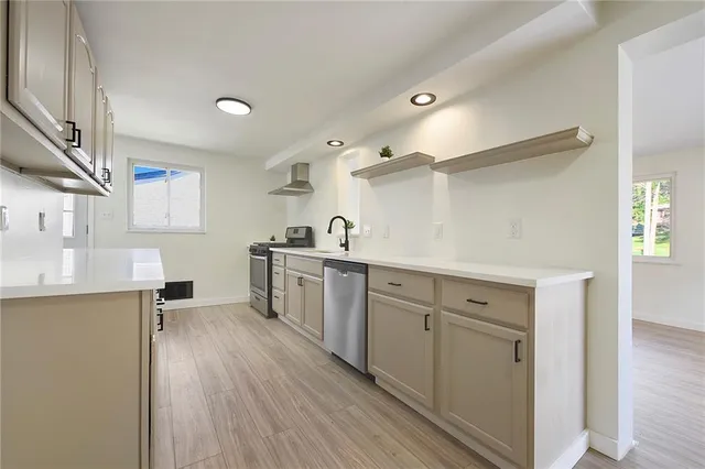 a kitchen with sink cabinets and wooden floor