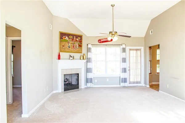 a view of empty room with a fireplace