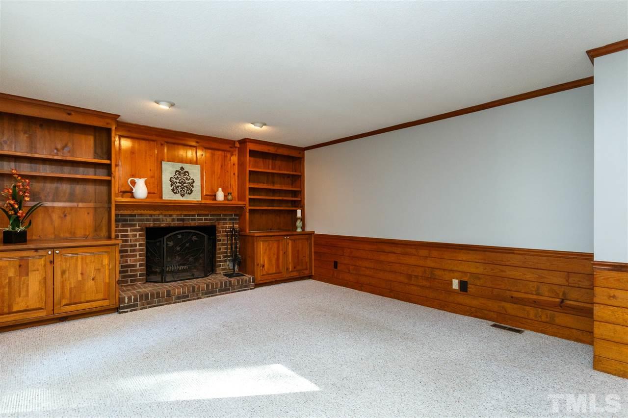 7420 Old Fox Trail Raleigh, NC 27613 - Photo 11 of 28 a view of an empty room with a fireplace and a window