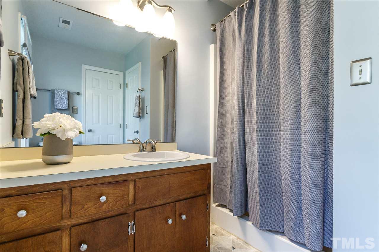 7420 Old Fox Trail Raleigh, NC 27613 - Photo 16 of 28 a bathroom with a sink and a mirror