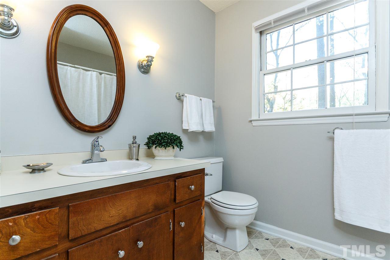 7420 Old Fox Trail Raleigh, NC 27613 - Photo 21 of 28 a bathroom with a toilet a sink and a mirror