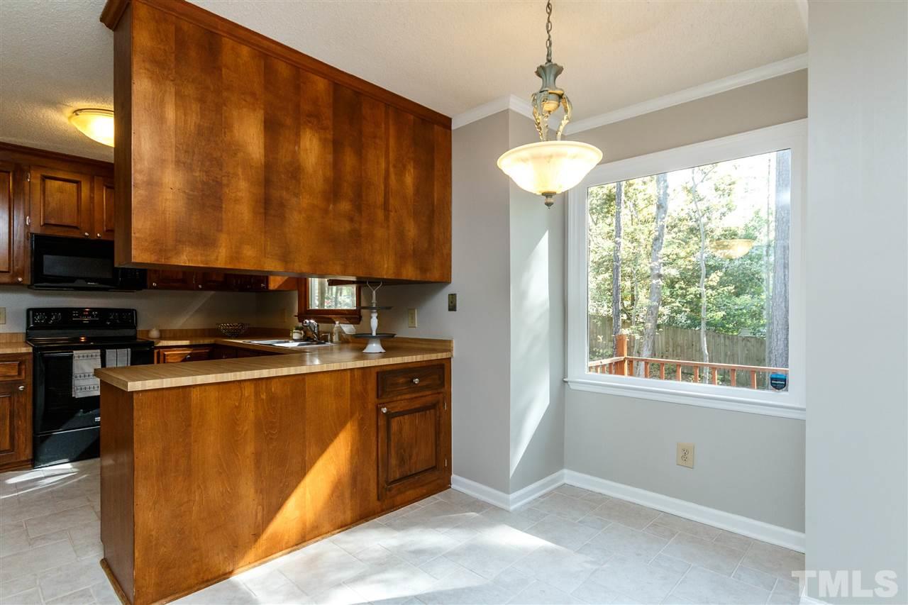 7420 Old Fox Trail Raleigh, NC 27613 - Photo 10 of 28 a kitchen with stainless steel appliances granite countertop a stove a sink dishwasher and a microwave oven with cabinets