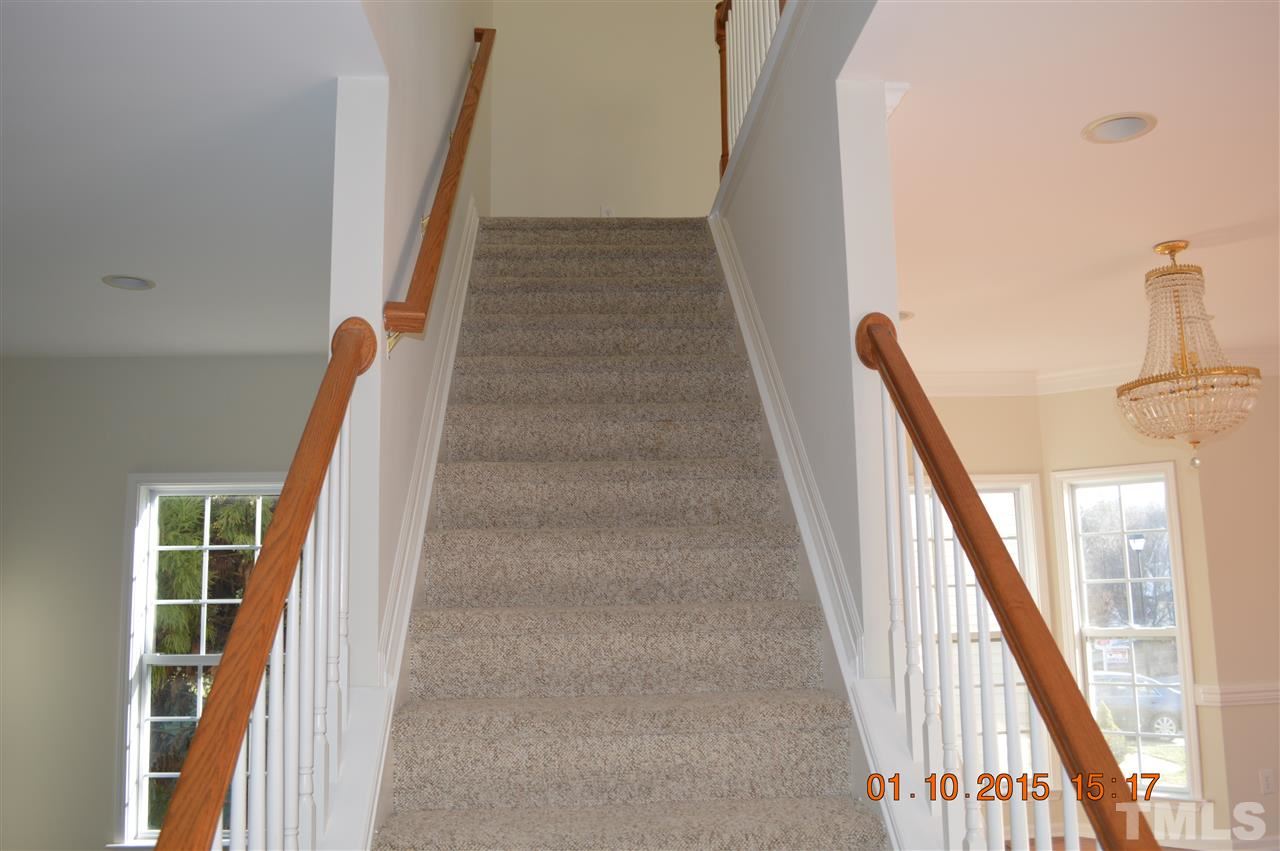 3216 Forest Mill Circle Raleigh, NC 27616 - Photo 14 of 25 a view of staircase with white walls and railing