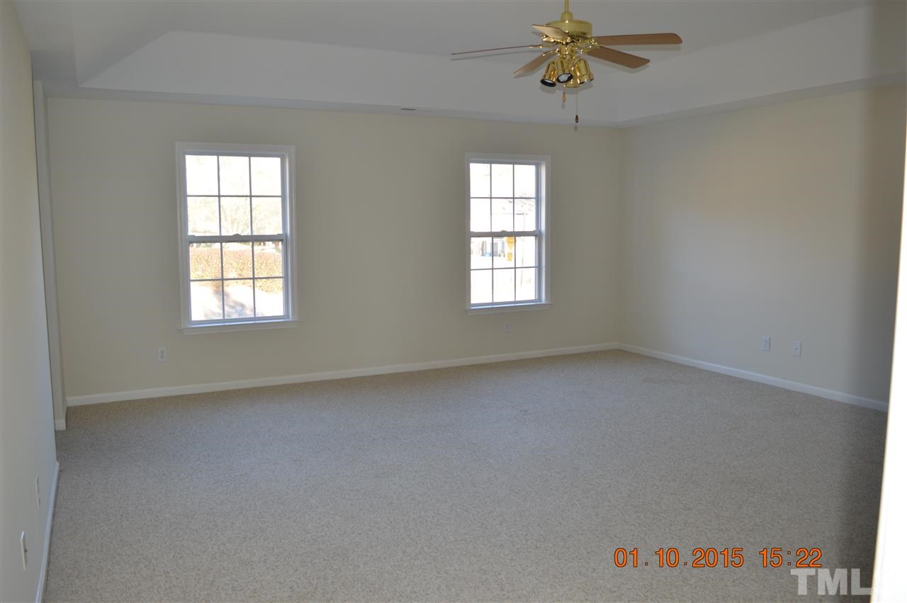 3216 Forest Mill Circle Raleigh, NC 27616 - Photo 18 of 25 an empty room with windows and chandelier fan