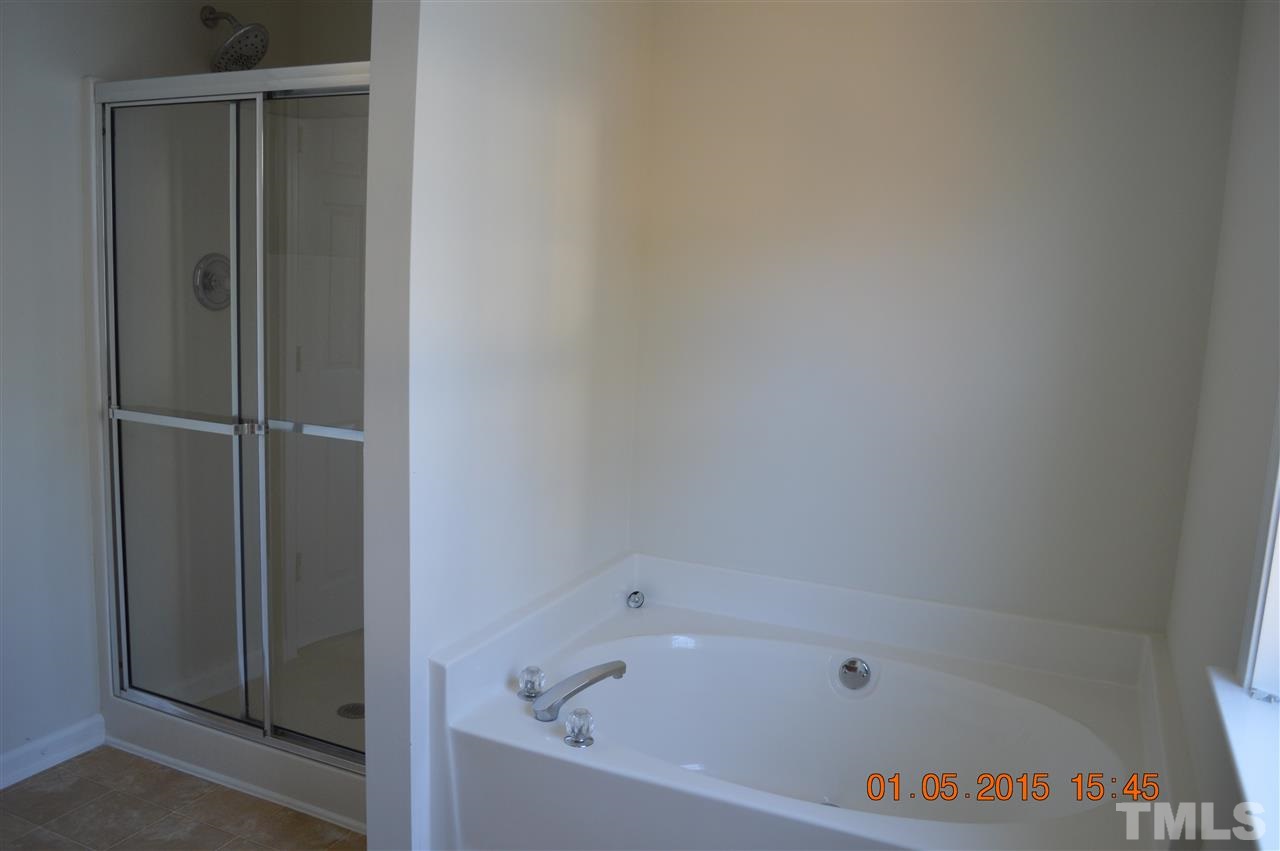 3216 Forest Mill Circle Raleigh, NC 27616 - Photo 20 of 25 a bathroom with a bathtub