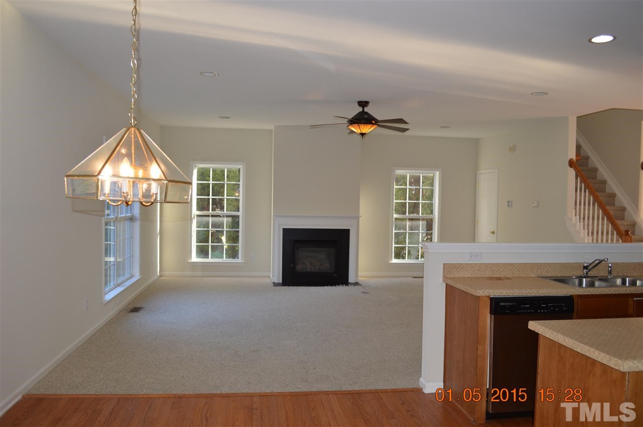 3216 Forest Mill Circle Raleigh, NC 27616 - Photo 5 of 25 a view of an empty room with a fireplace and a window