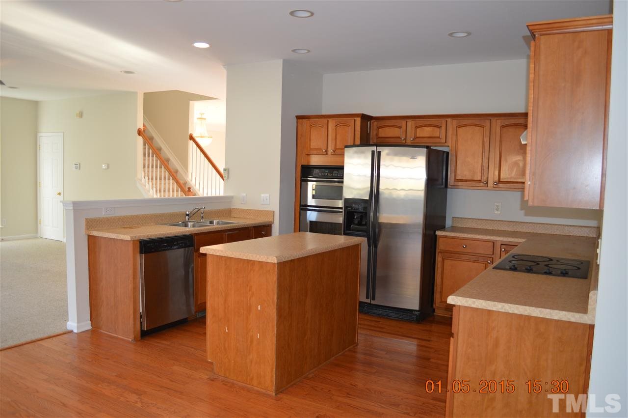 3216 Forest Mill Circle Raleigh, NC 27616 - Photo 7 of 25 a kitchen with stainless steel appliances granite countertop a refrigerator a sink and a stove