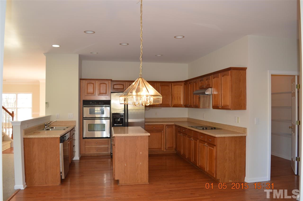 3216 Forest Mill Circle Raleigh, NC 27616 - Photo 8 of 25 a kitchen with stainless steel appliances kitchen island granite countertop a stove a sink and a refrigerator