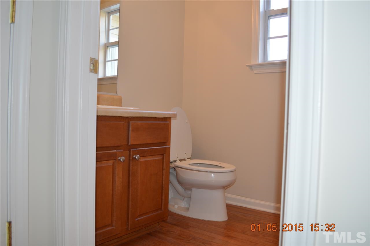 3216 Forest Mill Circle Raleigh, NC 27616 - Photo 9 of 25 a bathroom with a toilet and a sink