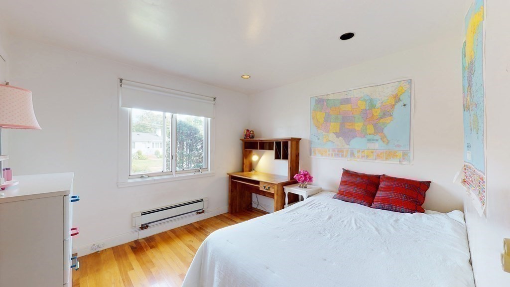 107 Truman Road Newton, MA 02459 - Photo 13 of 22 a bedroom with a bed and wooden floor