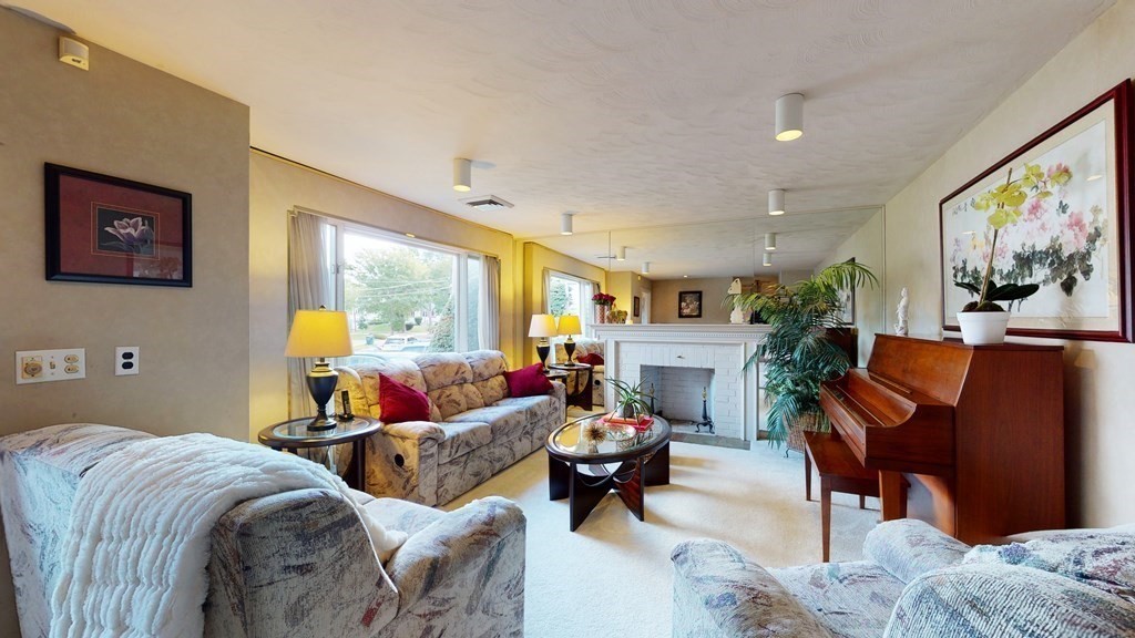 107 Truman Road Newton, MA 02459 - Photo 2 of 22 a living room with furniture a lamp and a large window